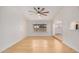 Bright living space featuring hardwood floors, modern ceiling fan, and a large window at 8201 W Tuckey Ln, Glendale, AZ 85303