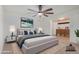 Comfortable main bedroom with soft lighting, plush carpet, and relaxing decor, making it a perfect retreat at 8201 W Tuckey Ln, Glendale, AZ 85303