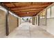 This covered patio has a concrete floor and beamed roof, as well as block wall to one side at 8201 W Tuckey Ln, Glendale, AZ 85303