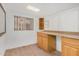 This room features wood floors, white walls, a window, and wood cabinetry at 8201 W Tuckey Ln, Glendale, AZ 85303