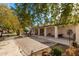 Large backyard with a covered patio, brickwork, mature landscaping, and beautiful outdoor space, great for relaxing and entertaining at 8310 W Daley Ln, Peoria, AZ 85383
