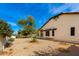 Expansive backyard featuring a well-maintained yard, mature trees, and a charming home exterior, creating a serene oasis at 8310 W Daley Ln, Peoria, AZ 85383
