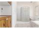 Bright bathroom featuring a glass block shower and a soaking tub at 8310 W Daley Ln, Peoria, AZ 85383