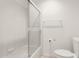 Tiled bathroom featuring a shower-tub combination with glass doors at 8310 W Daley Ln, Peoria, AZ 85383