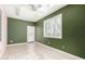 Bedroom featuring dark green walls, light colored tile flooring, and shutters at 8310 W Daley Ln, Peoria, AZ 85383