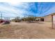 Wide shot of property with recreational vehicle, outbuildings, and desert landscaping at 8310 W Daley Ln, Peoria, AZ 85383