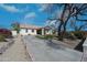 Single-level home showcasing desert landscaping and circular driveway at 8310 W Daley Ln, Peoria, AZ 85383