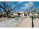 Charming single-story home with a winding driveway and desert landscaping at 8310 W Daley Ln, Peoria, AZ 85383