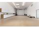 Expansive garage with ample storage, natural light, and a roll-up door perfect for car enthusiasts or workshop space at 8310 W Daley Ln, Peoria, AZ 85383