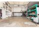 Large garage with ample room, shelving, and unique loft space, perfect for storage or hobbies at 8310 W Daley Ln, Peoria, AZ 85383