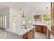 Spacious kitchen with tile island and custom wood cabinetry at 8310 W Daley Ln, Peoria, AZ 85383
