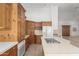 Bright kitchen featuring wood cabinetry, a tile cooktop island, and white appliances at 8310 W Daley Ln, Peoria, AZ 85383