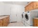 Functional laundry room with cabinets and modern washer and dryer at 8310 W Daley Ln, Peoria, AZ 85383