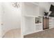Open living room with built-in shelving, a mounted TV, and a modern chandelier at 8310 W Daley Ln, Peoria, AZ 85383