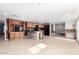Open-concept living room with a large, modern kitchen, tile flooring, and lots of natural light at 8310 W Daley Ln, Peoria, AZ 85383