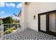 Spacious balcony showcasing detailed flooring and a black framed entry door at 8607 N Farview Dr, Scottsdale, AZ 85258