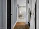 Hallway view to the bright bathroom with a tiled shower, wooden shower bench, and tile floors at 8607 N Farview Dr, Scottsdale, AZ 85258