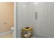 Modern bathroom featuring subway tile shower with glass enclosure and a wooden shower bench at 8607 N Farview Dr, Scottsdale, AZ 85258