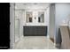 Bathroom featuring tile floors, double sink vanity, mirrors, walk-in shower, and tile floors at 8607 N Farview Dr, Scottsdale, AZ 85258