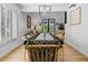 Bright dining room features a long table, modern lighting, and large windows with plantation shutters at 8607 N Farview Dr, Scottsdale, AZ 85258