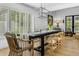 Elegant dining room features hardwood floors, a long table, modern lighting, and plantation shutters at 8607 N Farview Dr, Scottsdale, AZ 85258