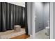 Spacious dressing area with full length curtains, unique stool and view into the bathroom at 8607 N Farview Dr, Scottsdale, AZ 85258