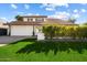 Charming two-story home featuring lush front lawn, tile roof, and a two-car garage at 8607 N Farview Dr, Scottsdale, AZ 85258