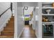 Hallway with hardwood floors and stairway leading to bar area with a wine cooler at 8607 N Farview Dr, Scottsdale, AZ 85258