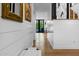 Inviting hallway showcasing hardwood floors, shiplap walls, and decorative mirrors, leading to rear door at 8607 N Farview Dr, Scottsdale, AZ 85258