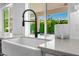 Bright kitchen sink with a view to the pool area at 8607 N Farview Dr, Scottsdale, AZ 85258