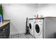 Functional laundry room with black and white patterned flooring and modern appliances at 8607 N Farview Dr, Scottsdale, AZ 85258