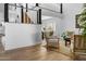 Bright living room with shiplap walls, staircase, hardwood floors, and comfortable seating arrangement at 8607 N Farview Dr, Scottsdale, AZ 85258