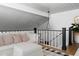 Second-story loft with white couch, decorative pillows, and a view of downstairs at 8607 N Farview Dr, Scottsdale, AZ 85258