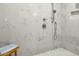 Tiled shower with marble tile, shower head, and shower handle at 8607 N Farview Dr, Scottsdale, AZ 85258