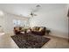 Spacious living room with tile flooring, ceiling fan and comfortable leather sofas, ideal for relaxation at 9949 E Legend Ct, Gold Canyon, AZ 85118