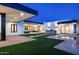 Backyard view featuring a modern pool, outdoor kitchen and dining area, and manicured landscaping at 10220 N 66Th St, Paradise Valley, AZ 85253