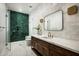 Stunning bathroom featuring a green tiled shower, marble floors, and a wood vanity at 10220 N 66Th St, Paradise Valley, AZ 85253