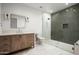 Modern bathroom featuring a glass enclosed shower and elegant vanity with marble counters at 10220 N 66Th St, Paradise Valley, AZ 85253