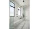 Modern bathroom with walk-in glass shower featuring rain shower head, marble tiling, and sleek fixtures at 10220 N 66Th St, Paradise Valley, AZ 85253