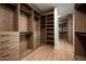 Spacious walk-in closet with custom wood shelving and drawers, providing ample storage and organization at 10220 N 66Th St, Paradise Valley, AZ 85253