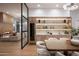 Open-concept dining room with custom wet bar, wine fridge and views of the living room at 10220 N 66Th St, Paradise Valley, AZ 85253
