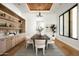 Chic dining room featuring custom cabinetry, modern lighting, and seating for ten at 10220 N 66Th St, Paradise Valley, AZ 85253