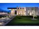 Chic modern home with elegant lighting, lush lawn, and a striking architectural design at 10220 N 66Th St, Paradise Valley, AZ 85253