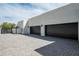 Three car garage with modern doors and a clean, paved driveway leading to the contemporary home at 10220 N 66Th St, Paradise Valley, AZ 85253