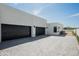 Three car garage with modern doors and a clean, paved driveway leading to the contemporary home at 10220 N 66Th St, Paradise Valley, AZ 85253