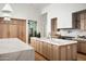 Bright kitchen featuring an oversized island, stainless appliances, and light wood cabinets at 10220 N 66Th St, Paradise Valley, AZ 85253