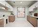 Well-lit laundry room with custom cabinets, modern fixtures, and ample counter space at 10220 N 66Th St, Paradise Valley, AZ 85253