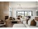 Airy living room featuring a cozy fireplace, plush seating, and seamless indoor-outdoor flow at 10220 N 66Th St, Paradise Valley, AZ 85253