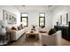 Bright living room with comfortable seating, stylish decor, large windows and natural light and modern artwork at 10220 N 66Th St, Paradise Valley, AZ 85253