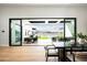Seamless indoor/outdoor living with dining and lounging spaces overlooking the backyard at 10220 N 66Th St, Paradise Valley, AZ 85253